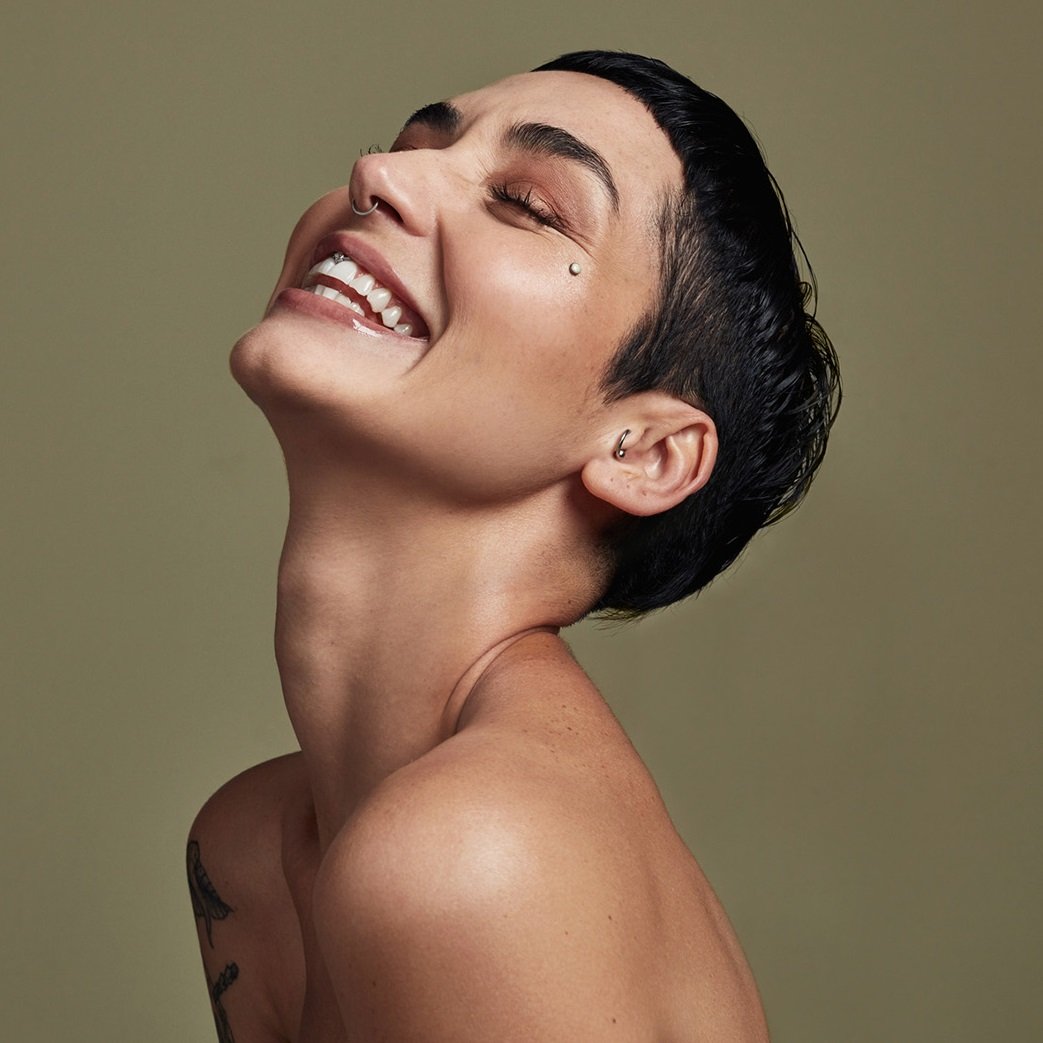 Model with dark hair, pixie cut